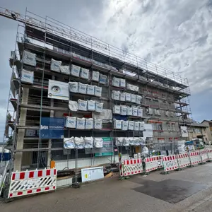 Scaffolding components (some from the construction site), machinery, and vehicles belonging to a construction company