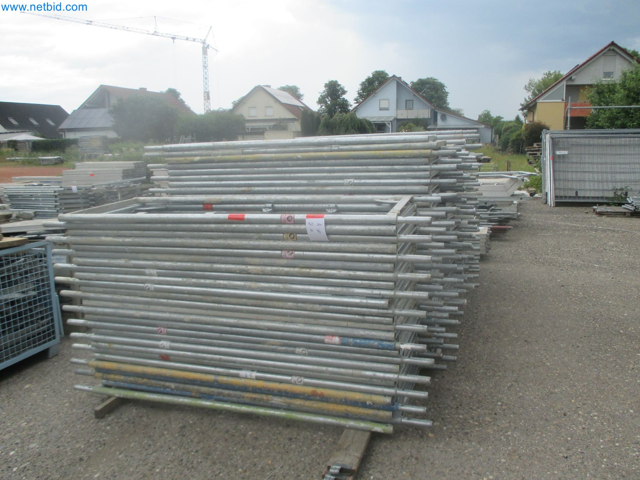 Scaffolding components (some from the construction site), machinery, and vehicles belonging to a construction company-17