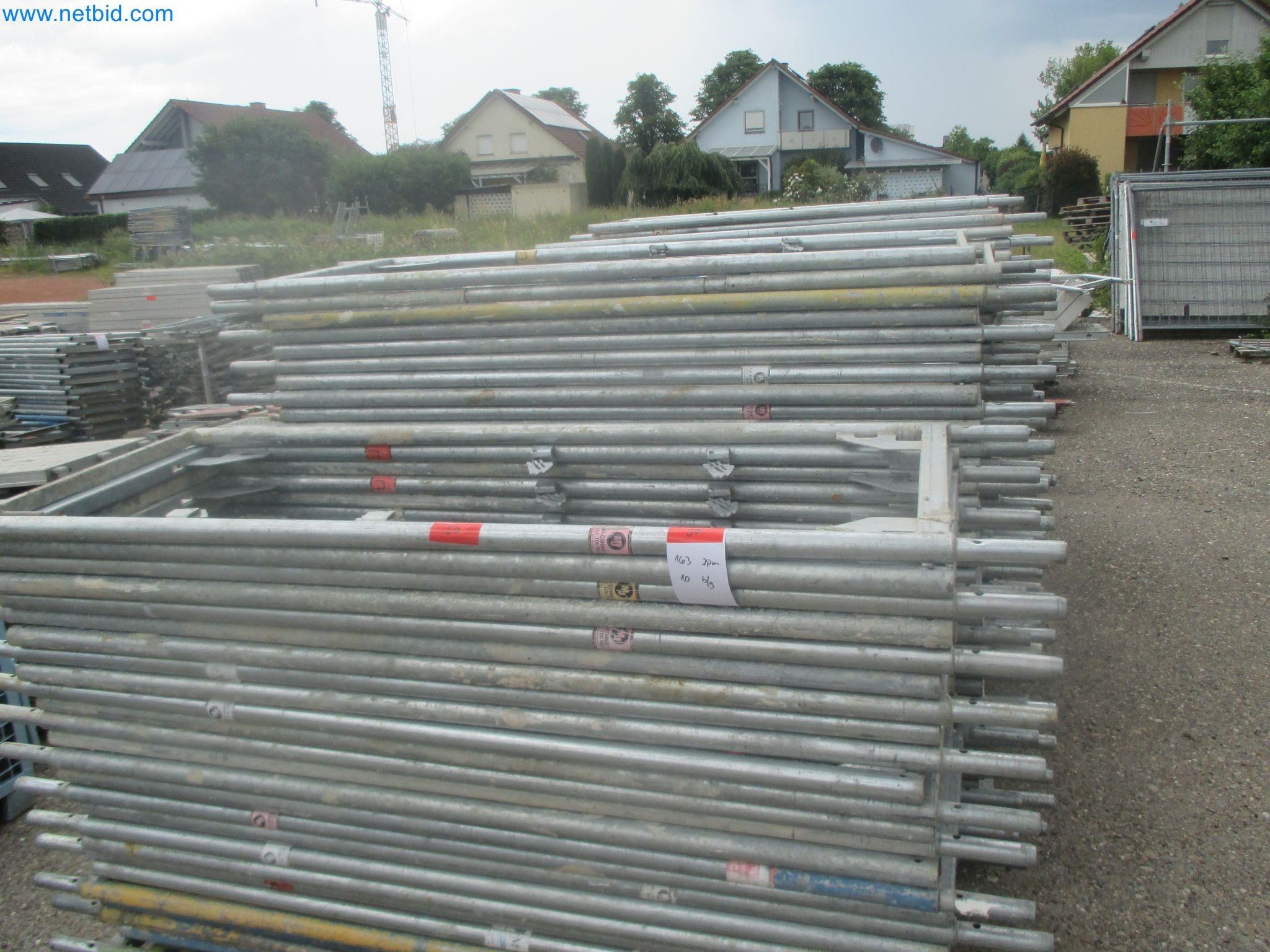 Scaffolding components (some from the construction site), machinery, and vehicles belonging to a construction company-18
