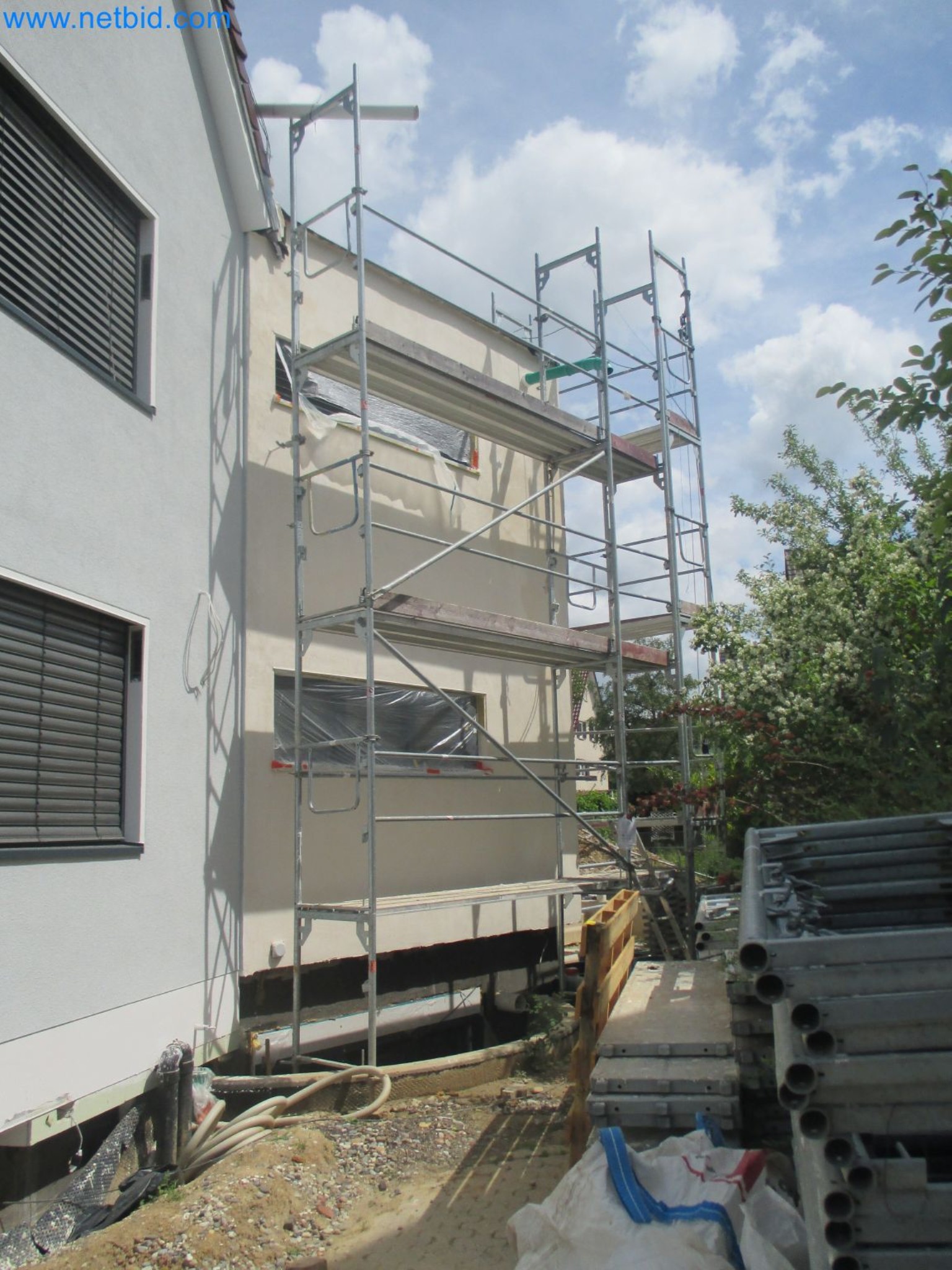 Scaffolding components (some from the construction site), machinery, and vehicles belonging to a construction company-7