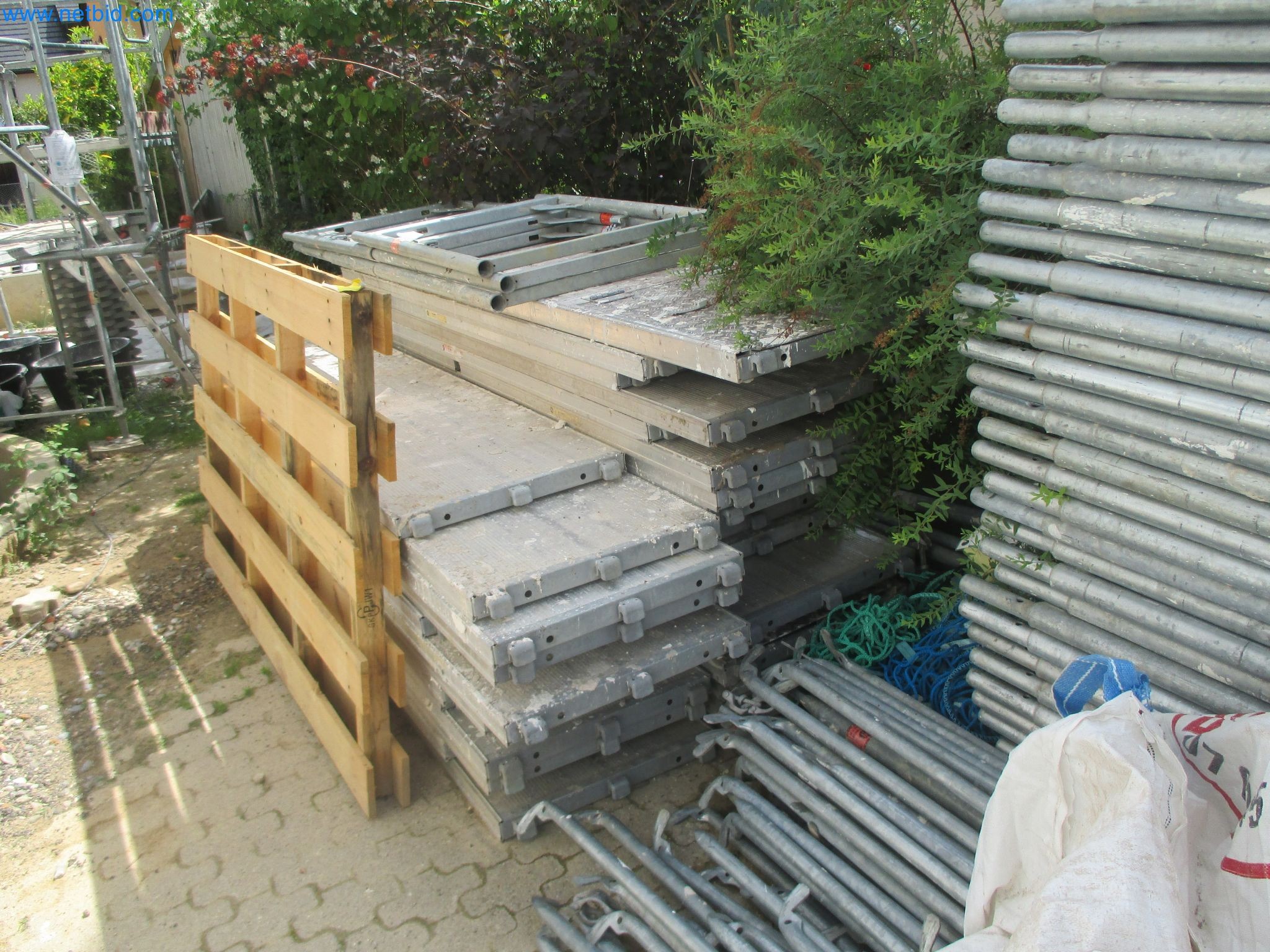 Scaffolding components (some from the construction site), machinery, and vehicles belonging to a construction company-9