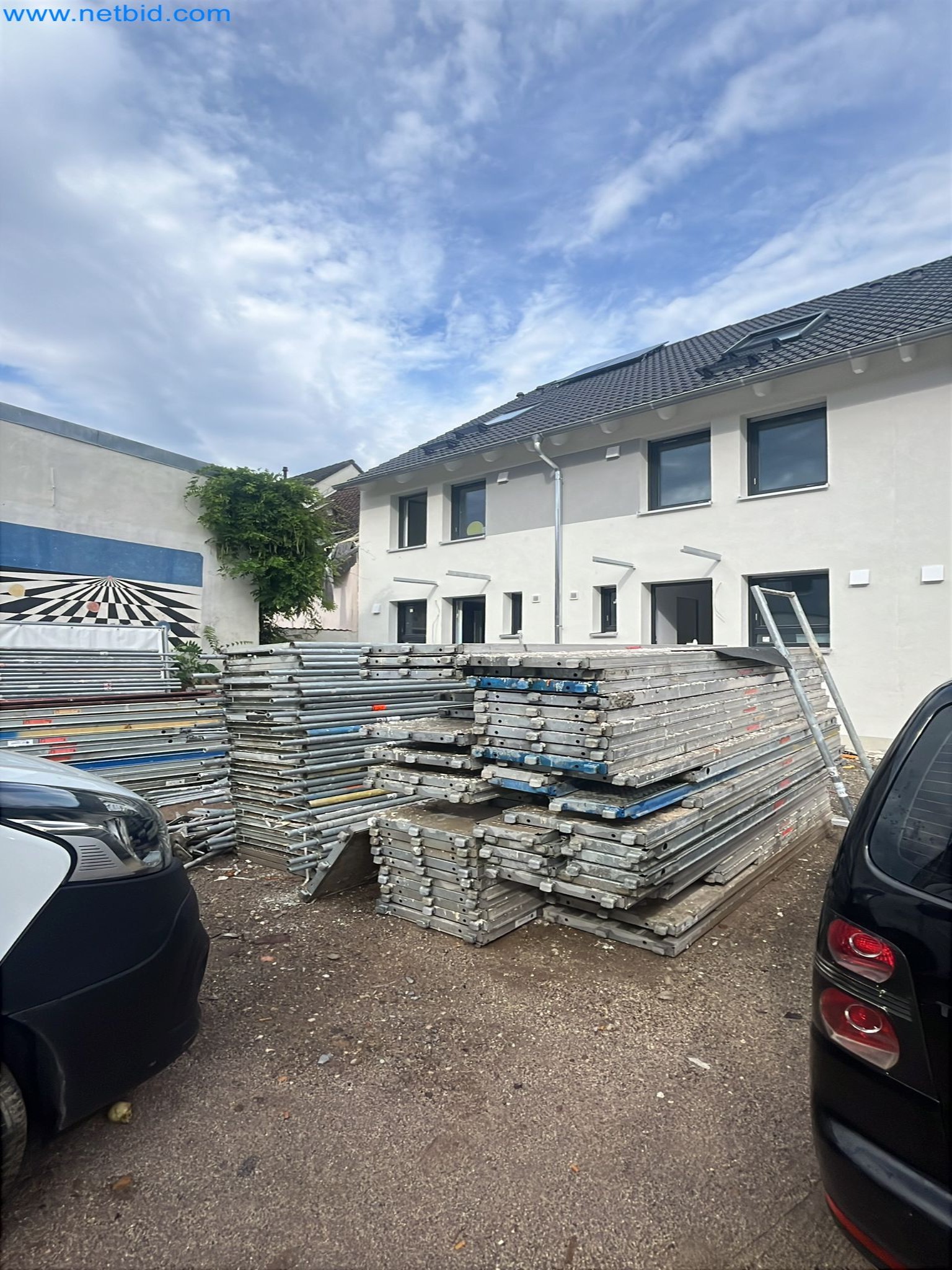 Scaffolding components (some from the construction site), machinery, and vehicles belonging to a construction company-1