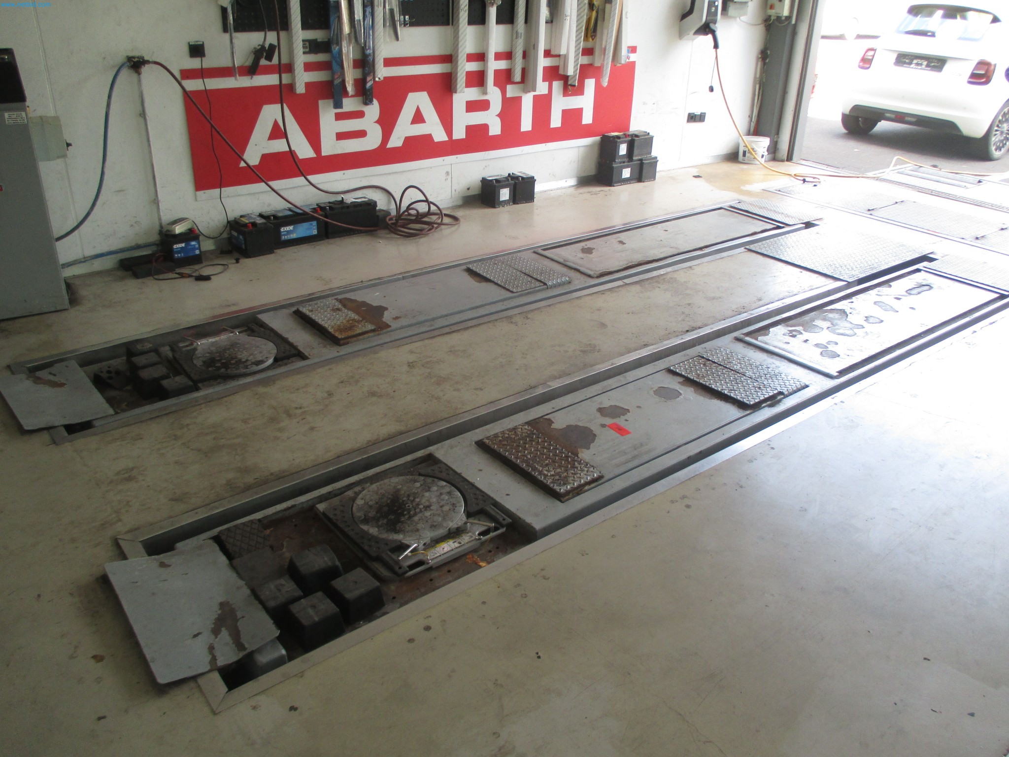 Passenger cars, electric cars, and automotive repair shop equipment at a Fiat dealership-1