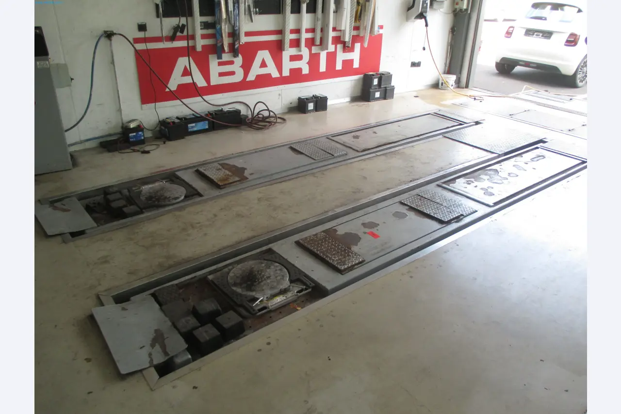 Passenger cars, electric cars, and automotive repair shop equipment at a Fiat dealership-1