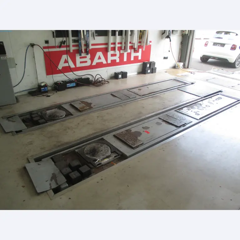 Passenger cars, electric cars, and automotive repair shop equipment at a Fiat dealership-1