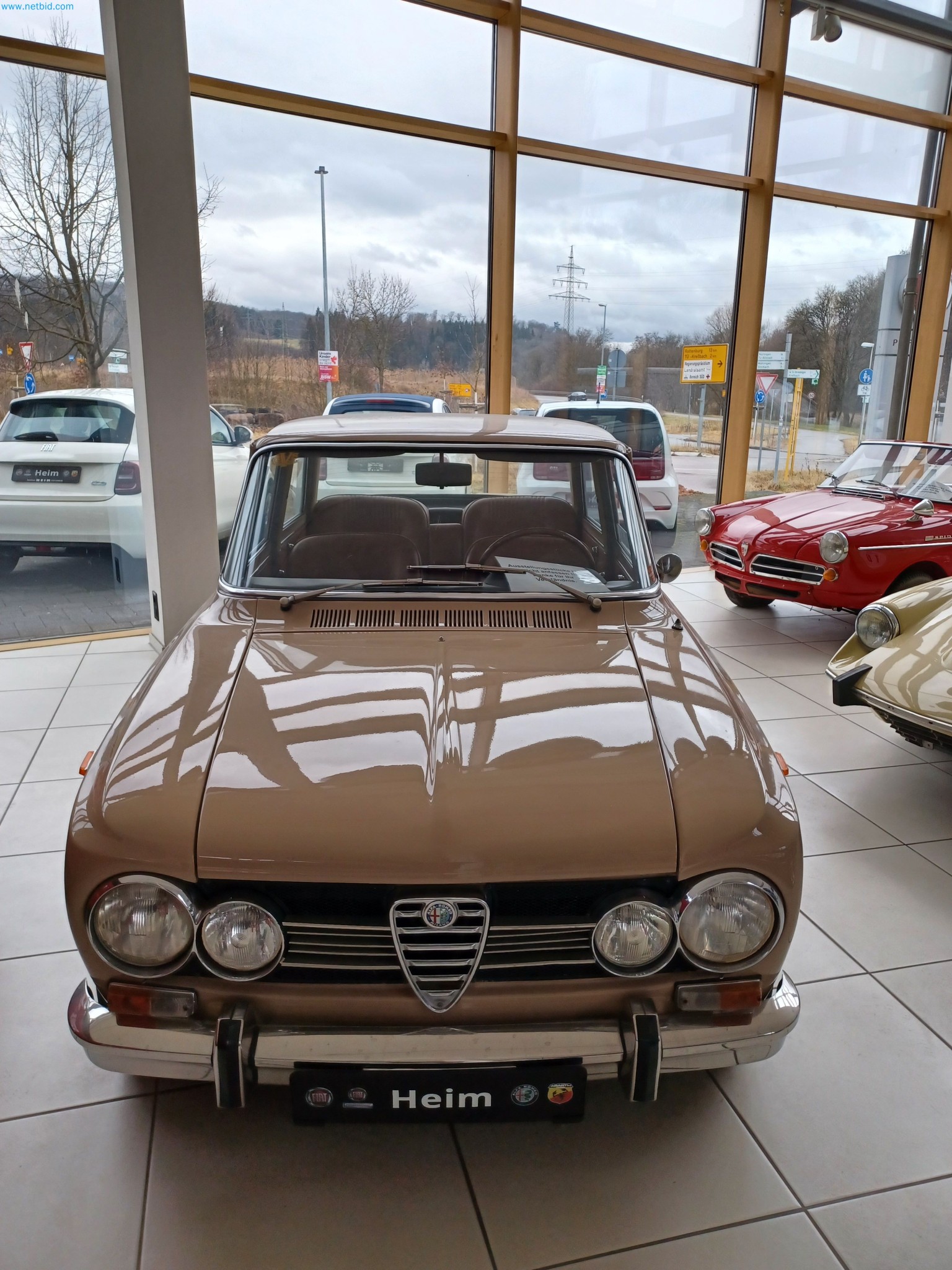 Passenger cars, electric cars, and automotive repair shop equipment at a Fiat dealership-1
