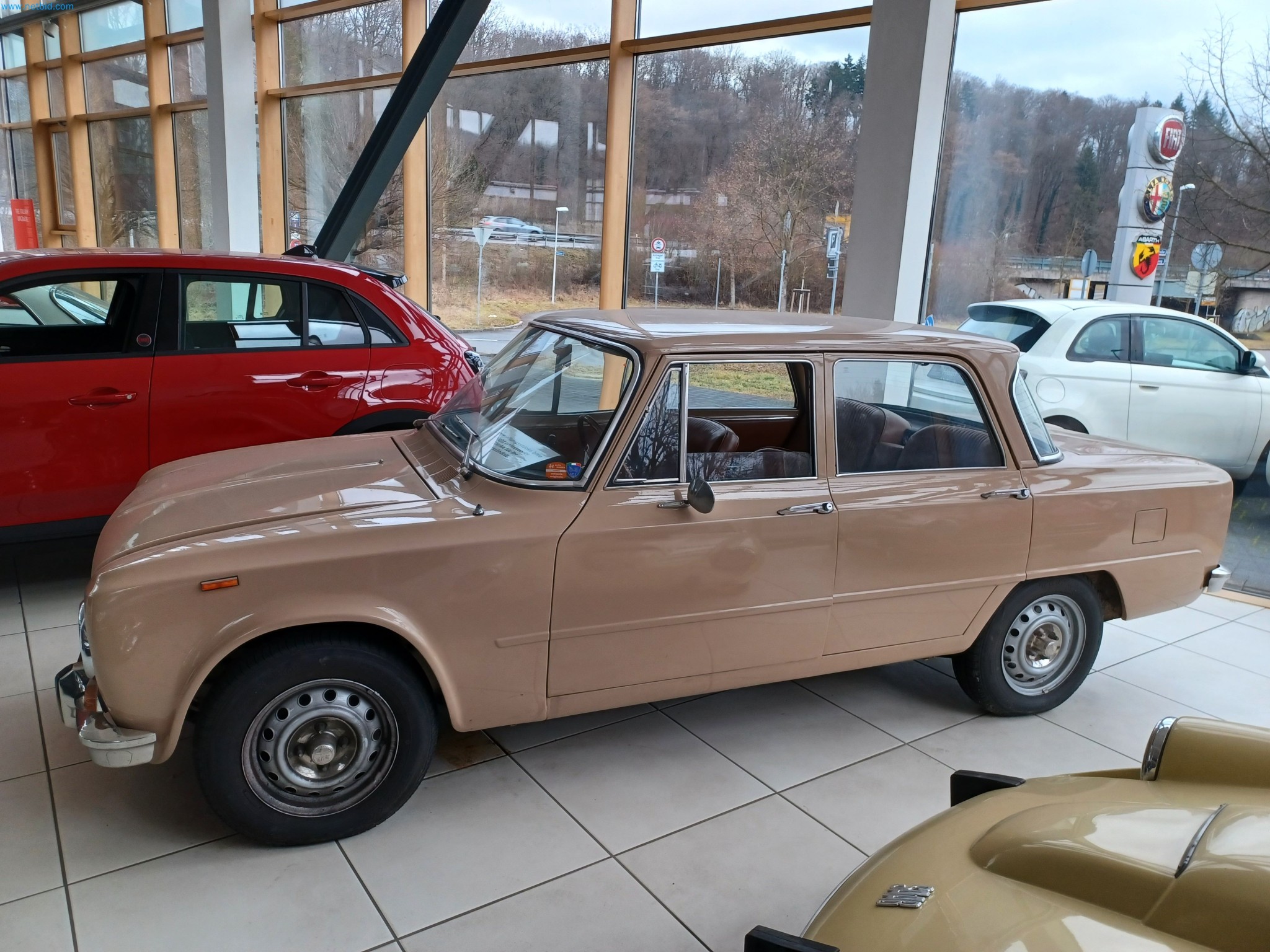 Passenger cars, electric cars, and automotive repair shop equipment at a Fiat dealership-2