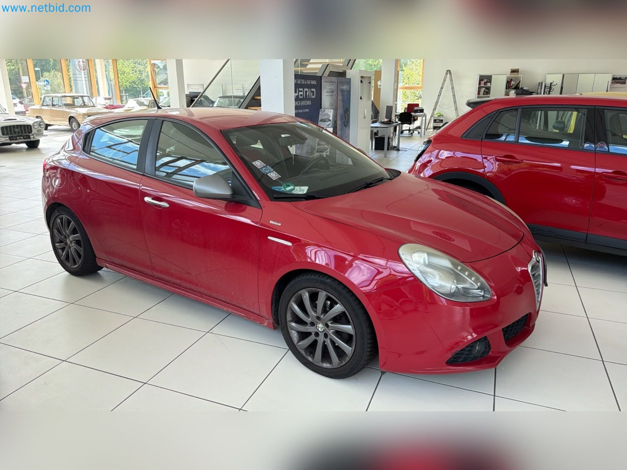 Passenger cars, electric cars, and automotive repair shop equipment at a Fiat dealership-2