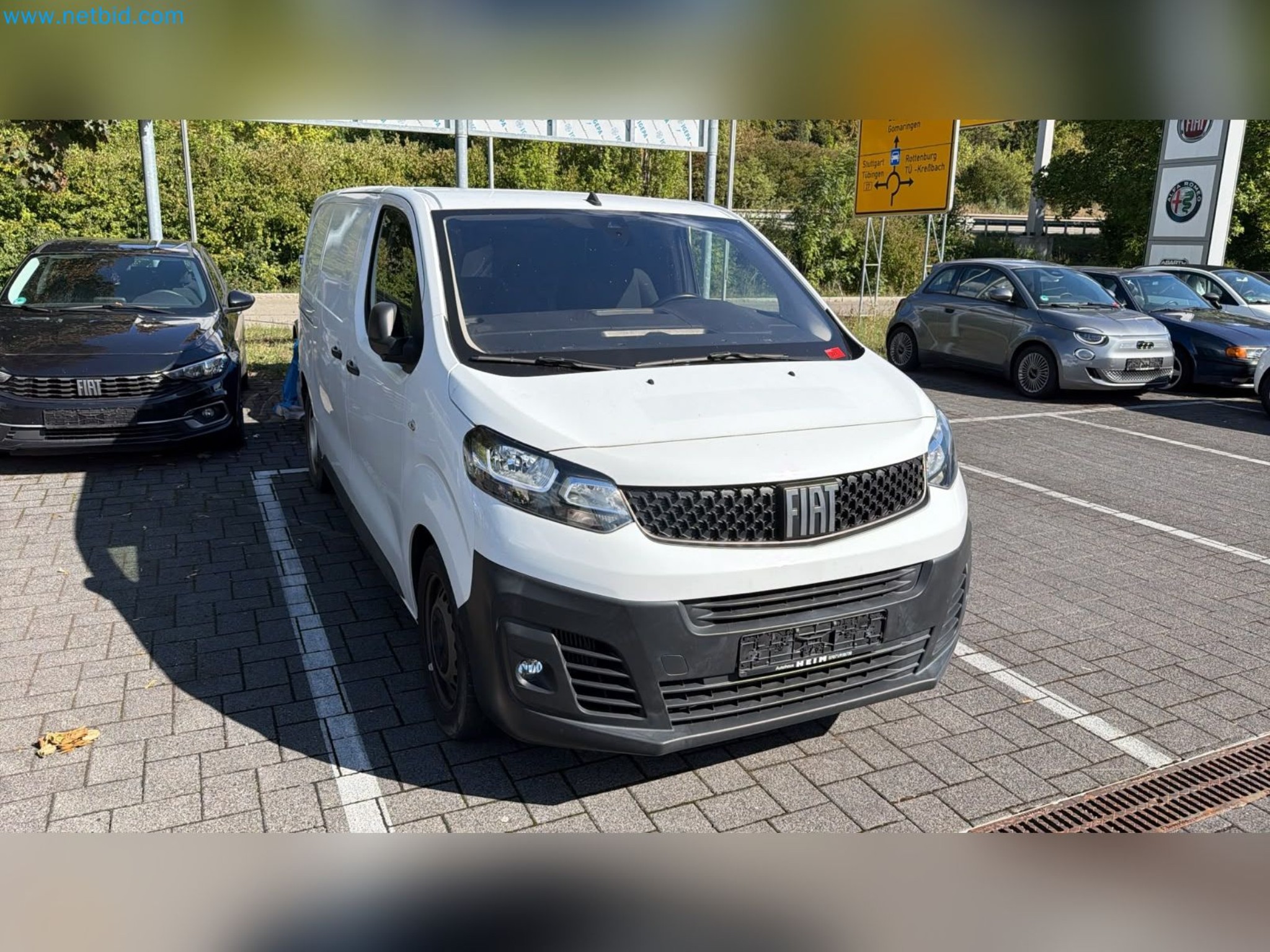 Passenger cars, electric cars, and automotive repair shop equipment at a Fiat dealership-2