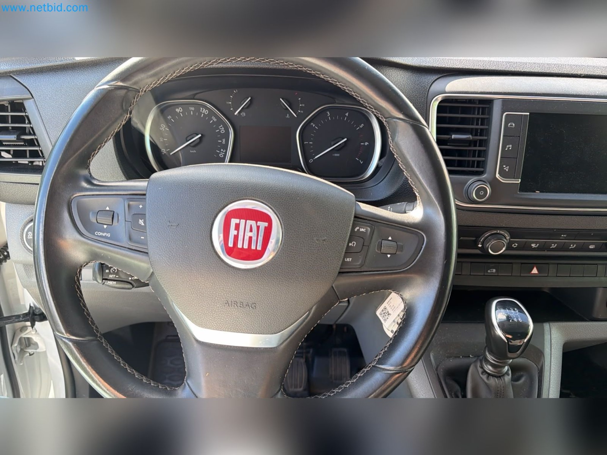 Passenger cars, electric cars, and automotive repair shop equipment at a Fiat dealership-4