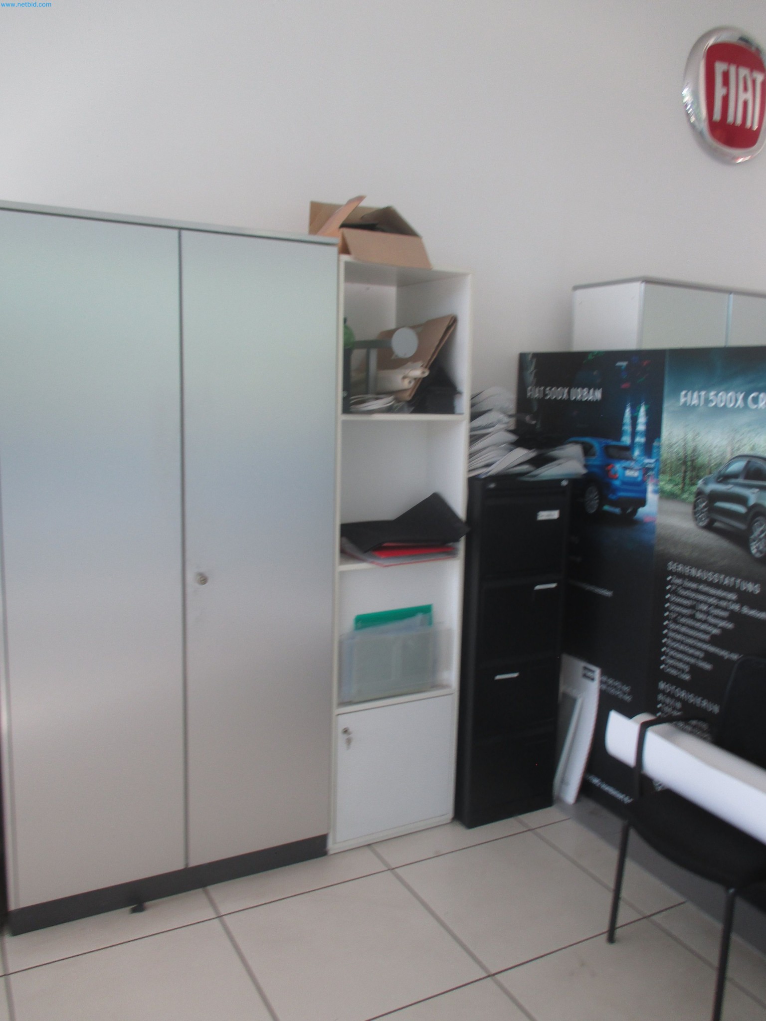 Passenger cars, electric cars, and automotive repair shop equipment at a Fiat dealership-2