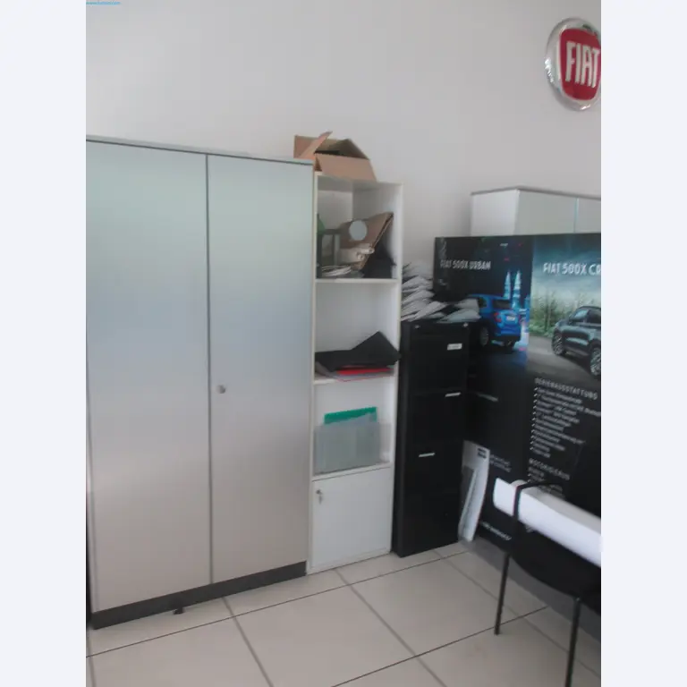 Passenger cars, electric cars, and automotive repair shop equipment at a Fiat dealership-2