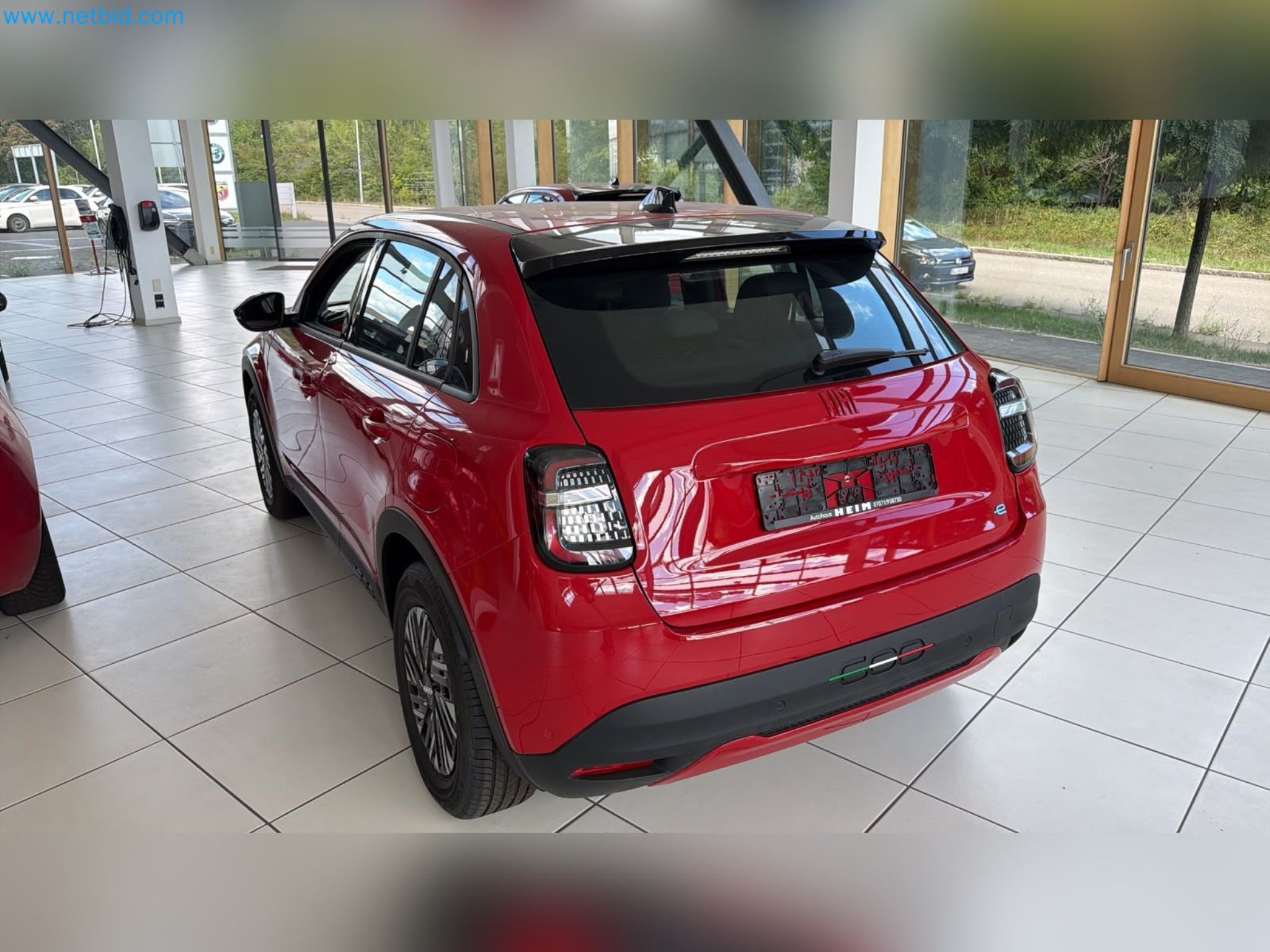 Passenger cars, electric cars, and automotive repair shop equipment at a Fiat dealership-10