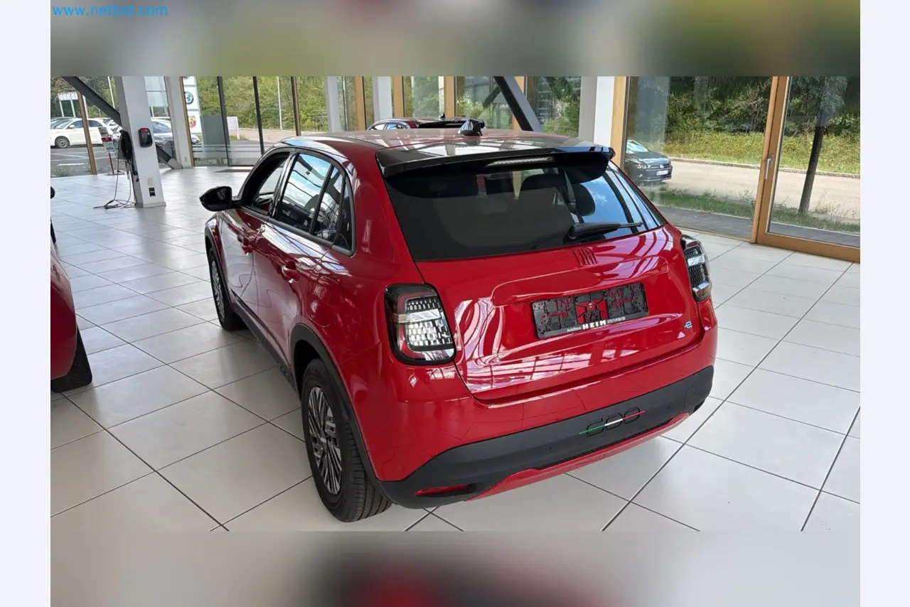 Passenger cars, electric cars, and automotive repair shop equipment at a Fiat dealership-10