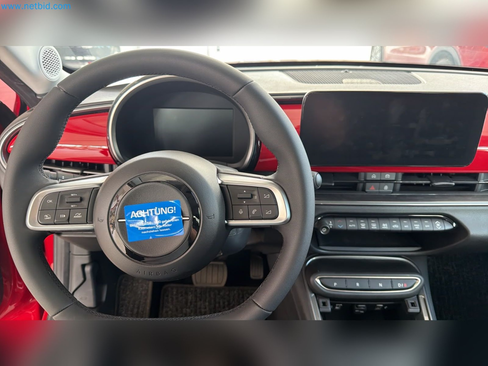 Passenger cars, electric cars, and automotive repair shop equipment at a Fiat dealership-14