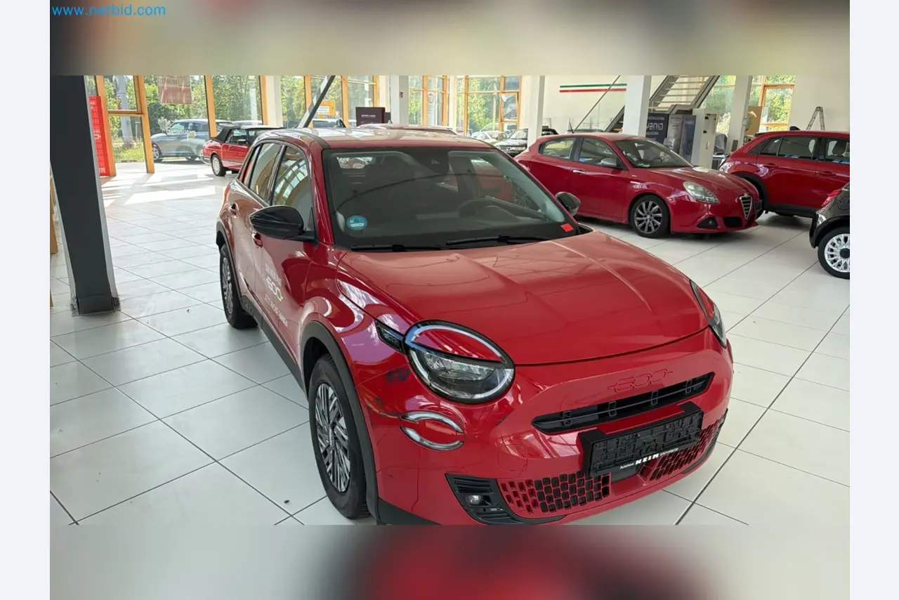 Passenger cars, electric cars, and automotive repair shop equipment at a Fiat dealership-1