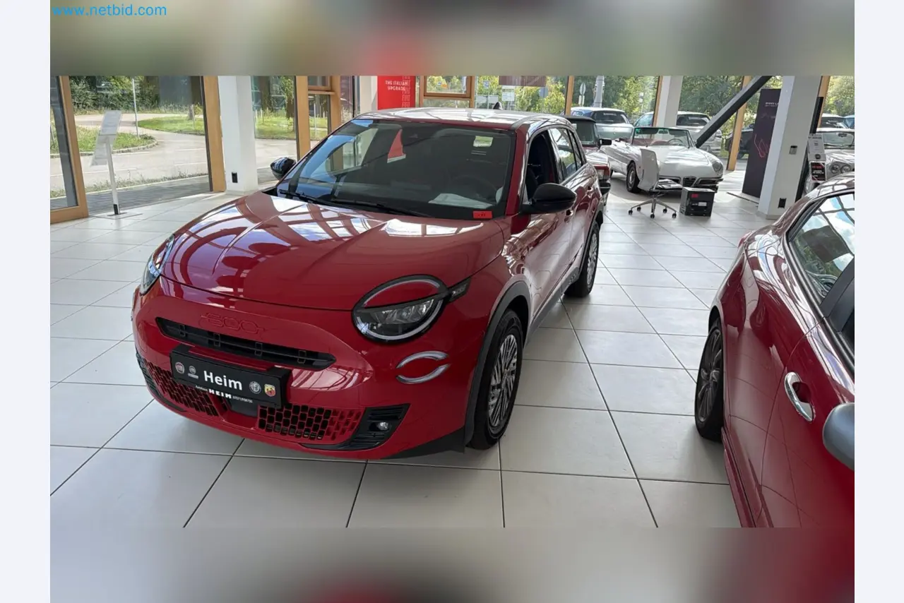 Passenger cars, electric cars, and automotive repair shop equipment at a Fiat dealership-2