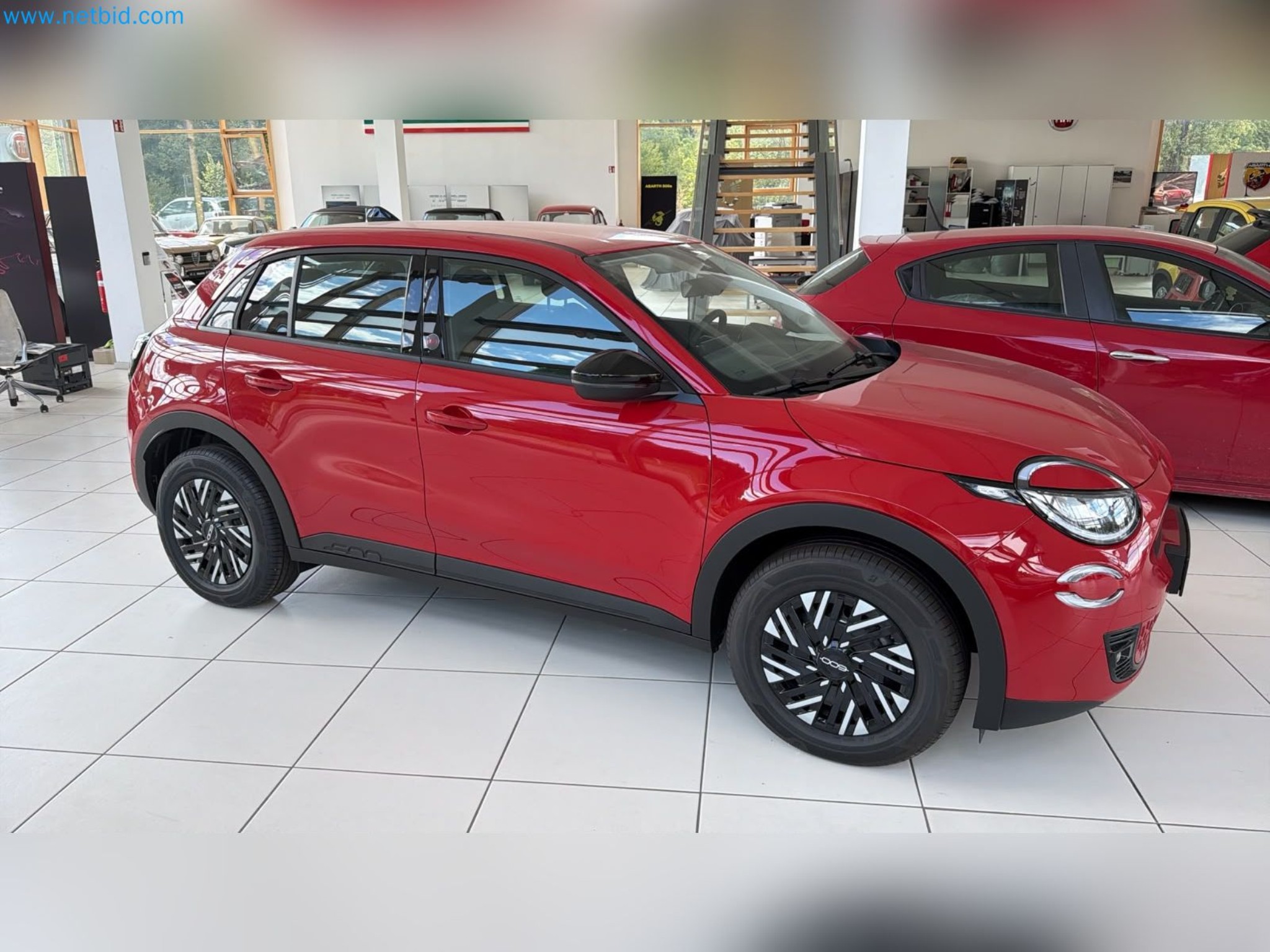 Passenger cars, electric cars, and automotive repair shop equipment at a Fiat dealership-8