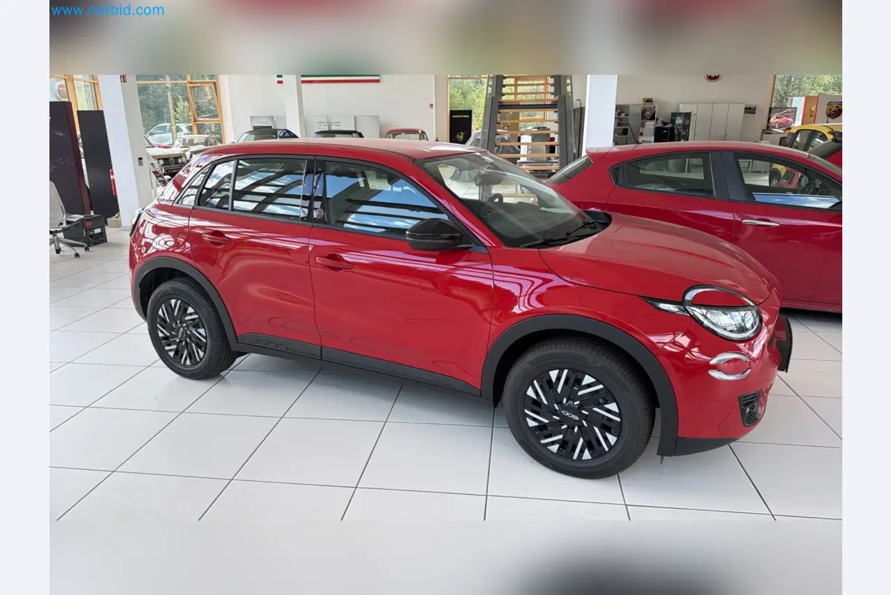 Passenger cars, electric cars, and automotive repair shop equipment at a Fiat dealership-8