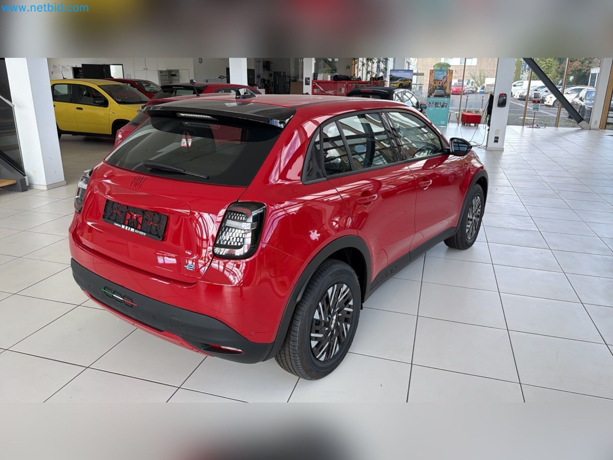Passenger cars, electric cars, and automotive repair shop equipment at a Fiat dealership-9