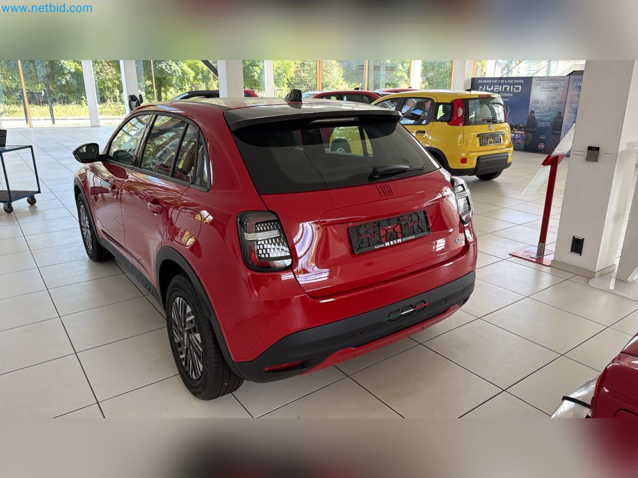 Passenger cars, electric cars, and automotive repair shop equipment at a Fiat dealership-11