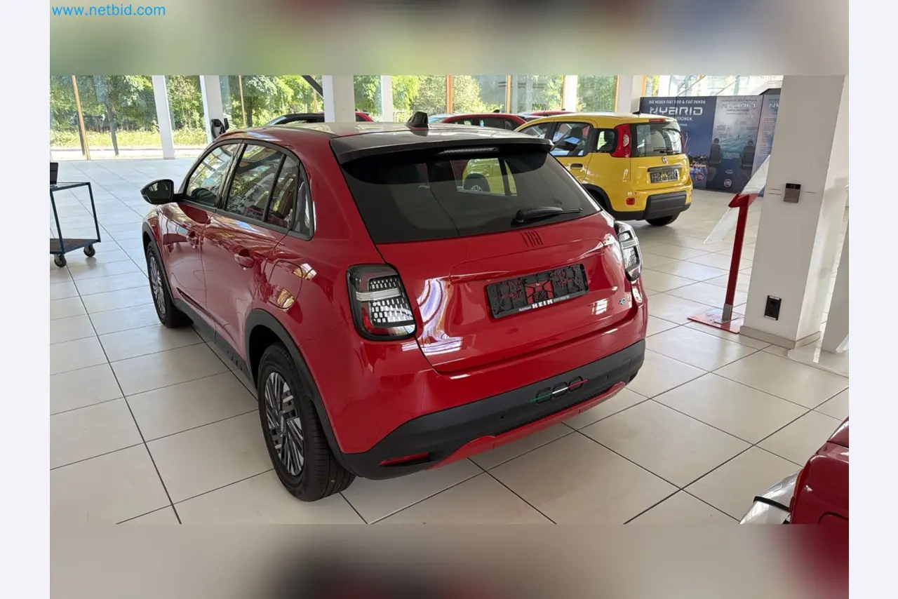 Passenger cars, electric cars, and automotive repair shop equipment at a Fiat dealership-11