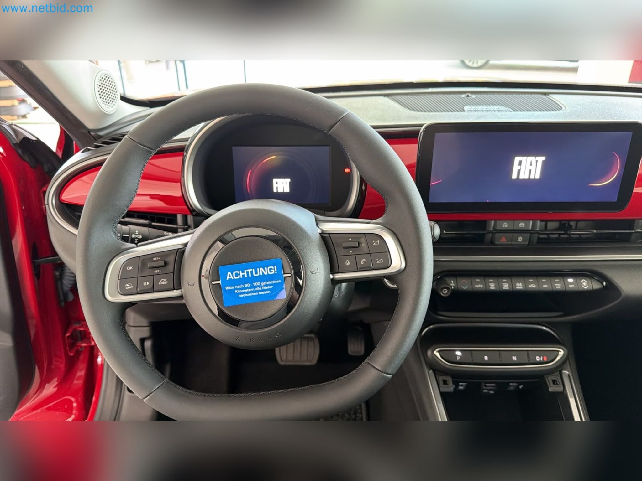 Passenger cars, electric cars, and automotive repair shop equipment at a Fiat dealership-12