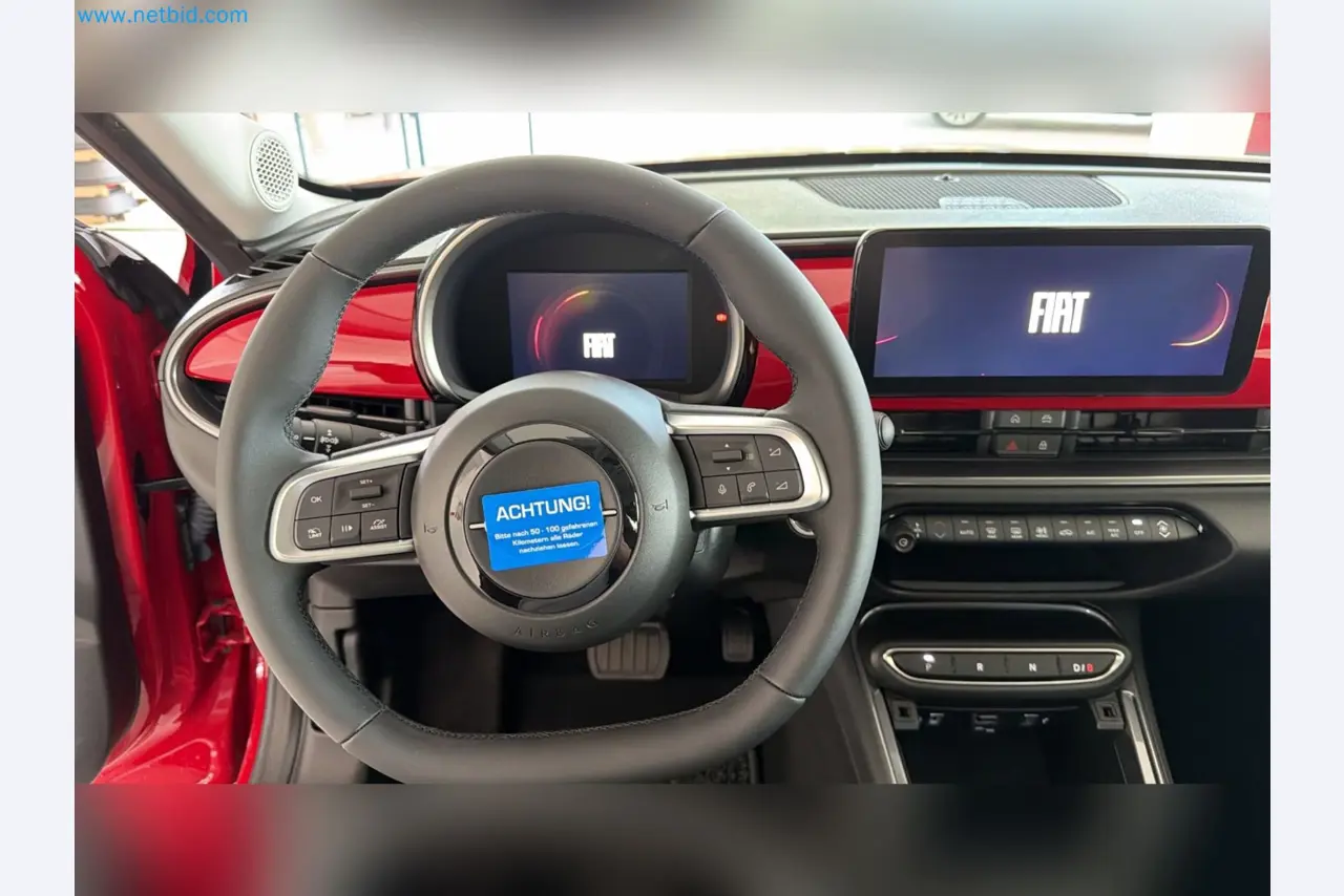 Passenger cars, electric cars, and automotive repair shop equipment at a Fiat dealership-12