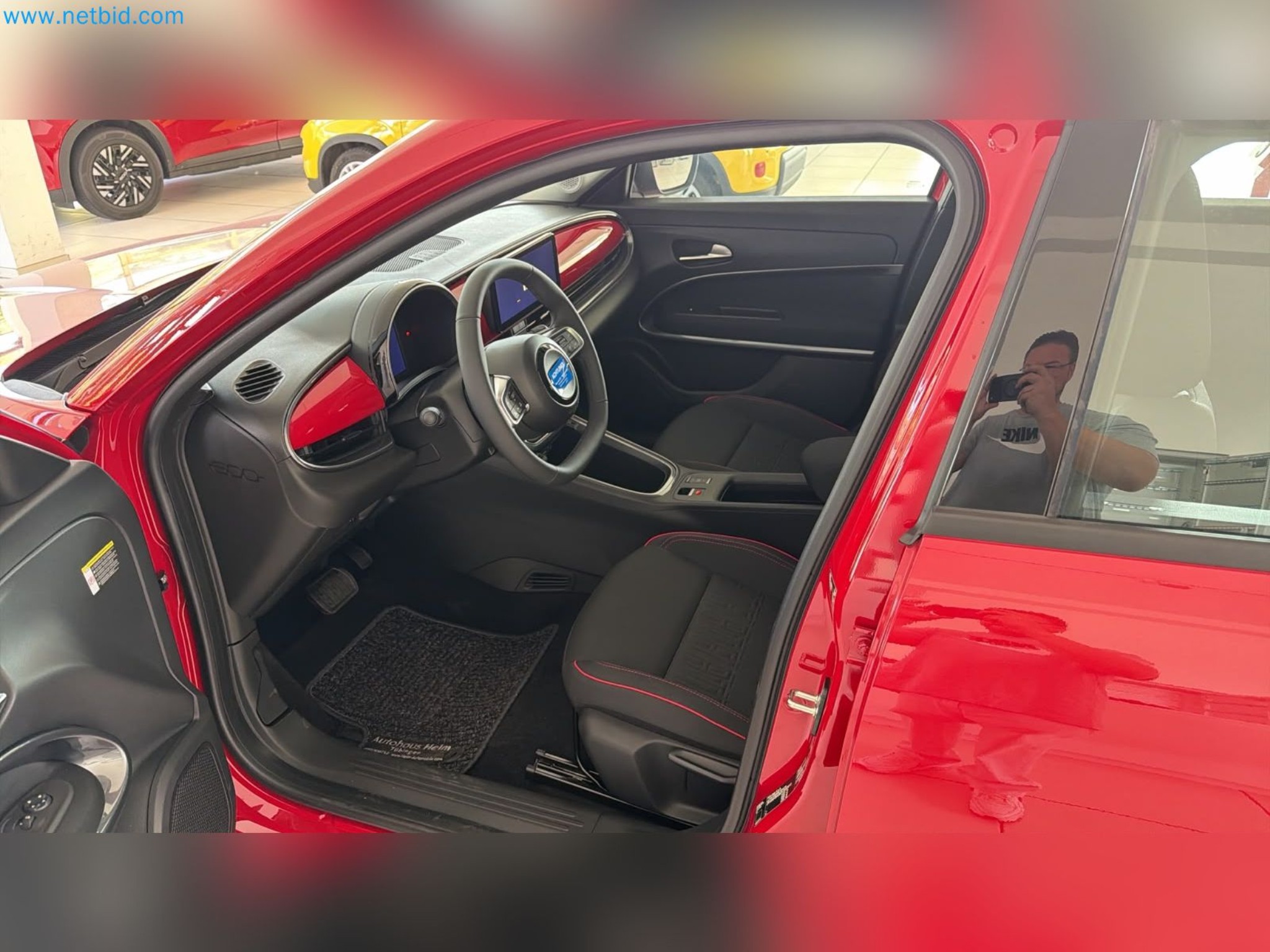 Passenger cars, electric cars, and automotive repair shop equipment at a Fiat dealership-13