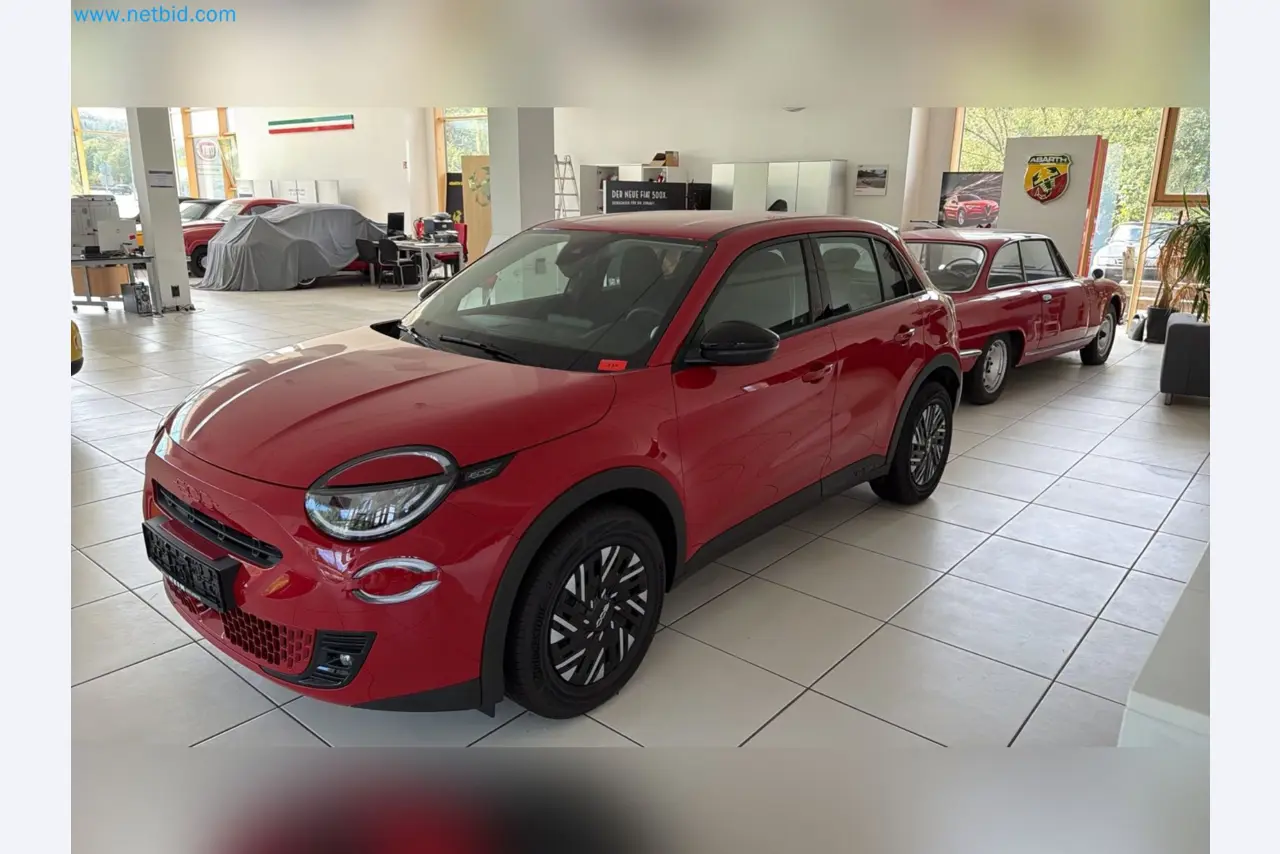 Passenger cars, electric cars, and automotive repair shop equipment at a Fiat dealership-1