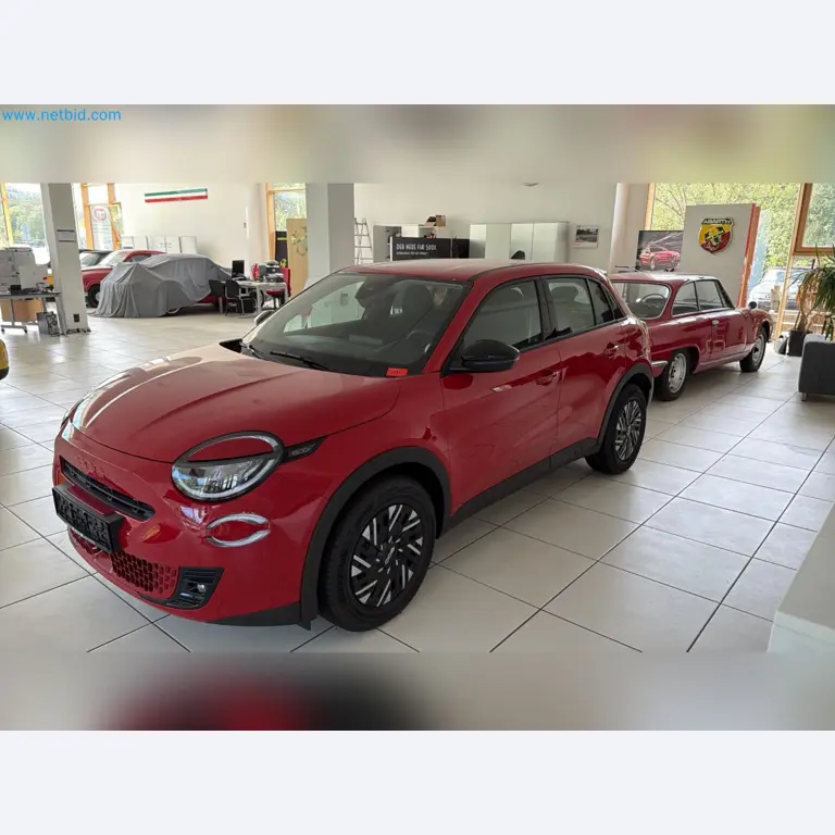 Passenger cars, electric cars, and automotive repair shop equipment at a Fiat dealership-1