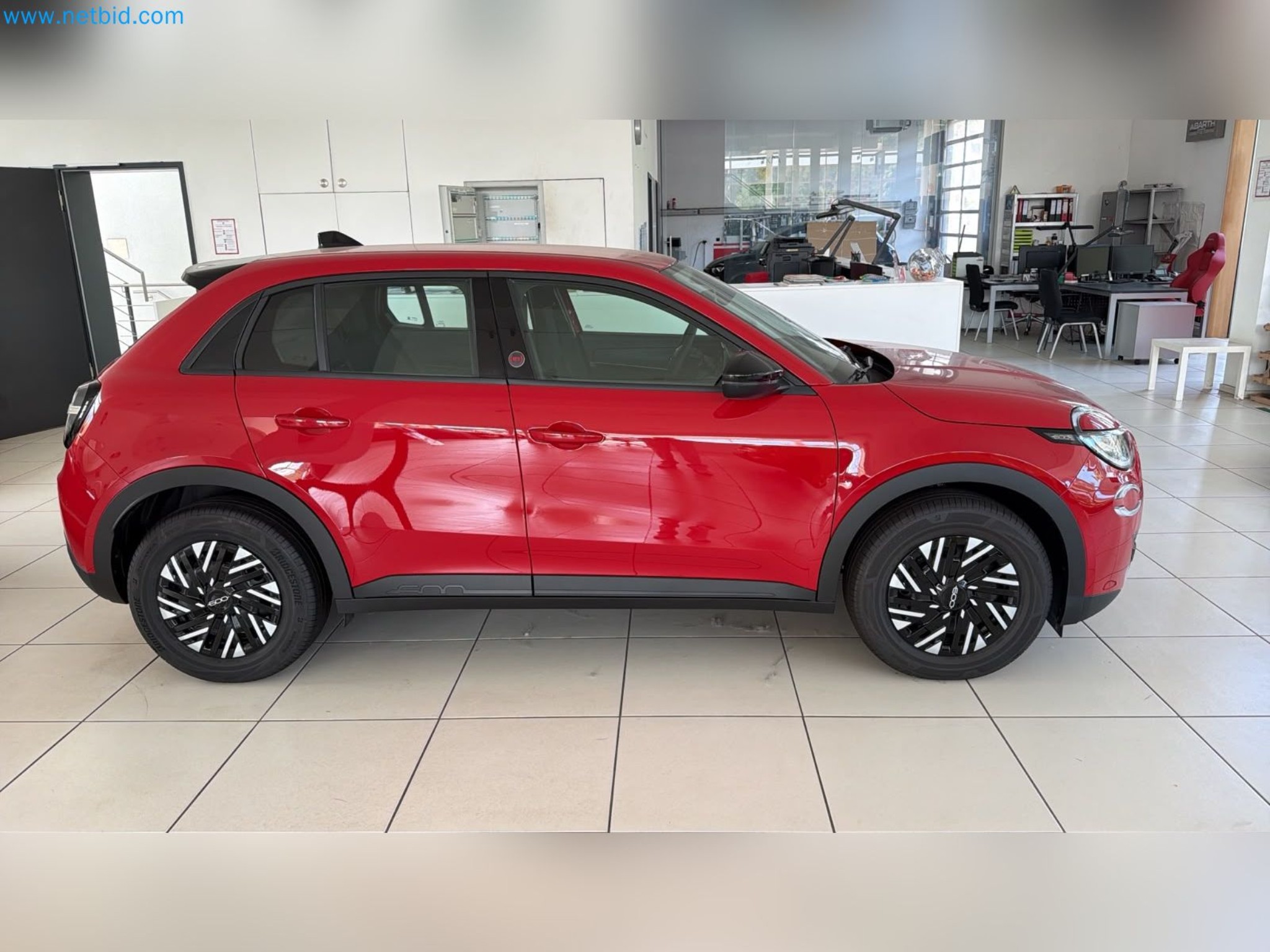 Passenger cars, electric cars, and automotive repair shop equipment at a Fiat dealership-2