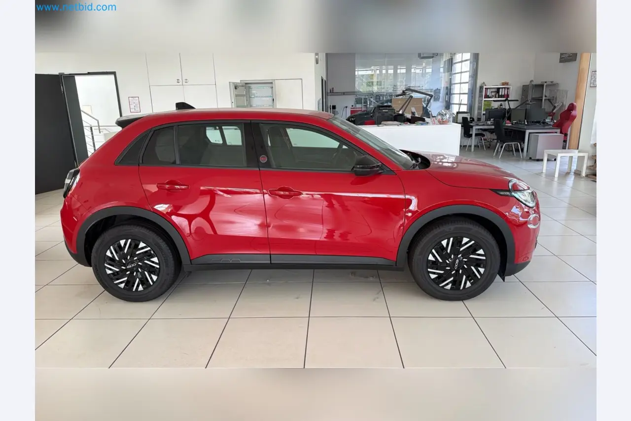 Passenger cars, electric cars, and automotive repair shop equipment at a Fiat dealership-2