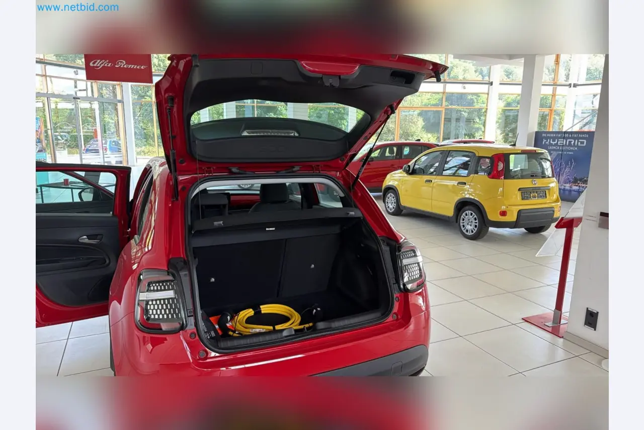 Passenger cars, electric cars, and automotive repair shop equipment at a Fiat dealership-3