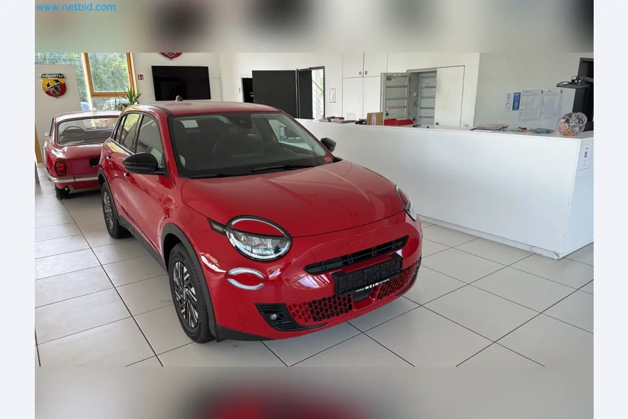 Passenger cars, electric cars, and automotive repair shop equipment at a Fiat dealership-8