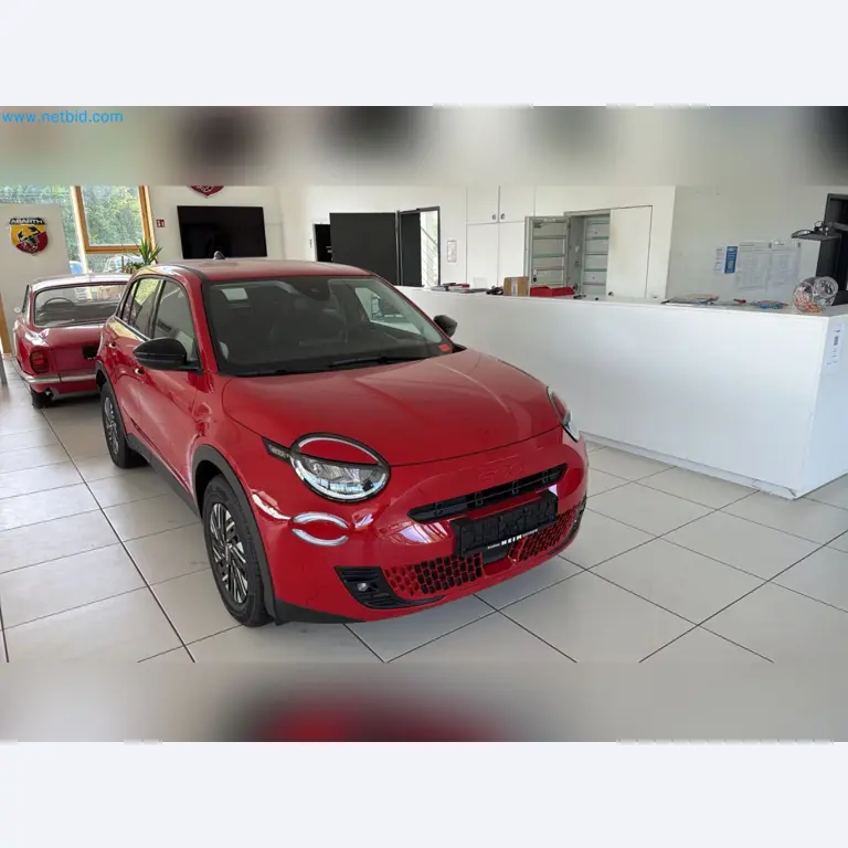 Passenger cars, electric cars, and automotive repair shop equipment at a Fiat dealership-8