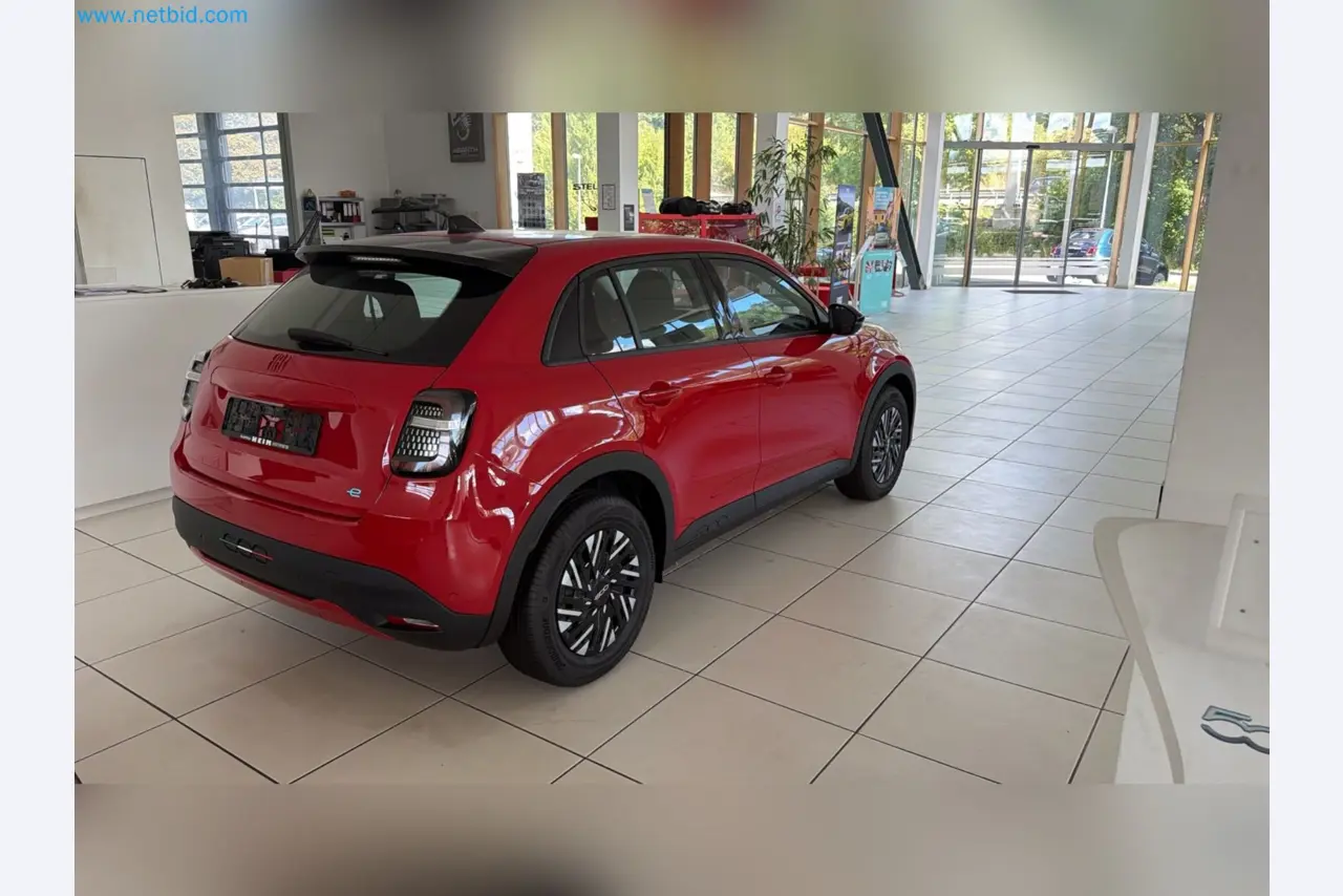 Passenger cars, electric cars, and automotive repair shop equipment at a Fiat dealership-9