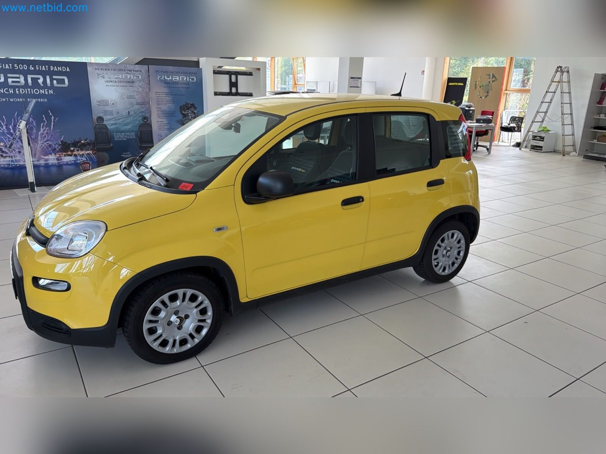Passenger cars, electric cars, and automotive repair shop equipment at a Fiat dealership-1