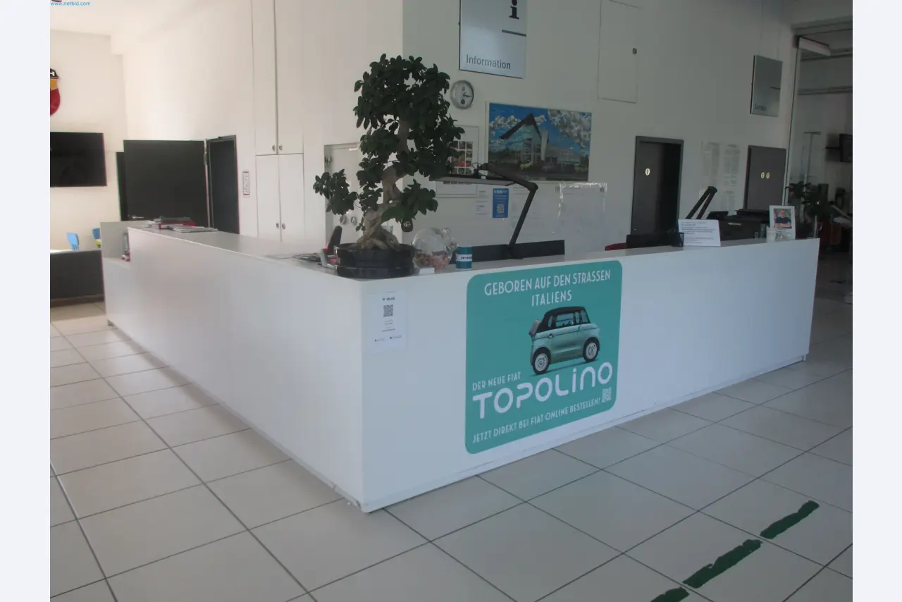Passenger cars, electric cars, and automotive repair shop equipment at a Fiat dealership-1