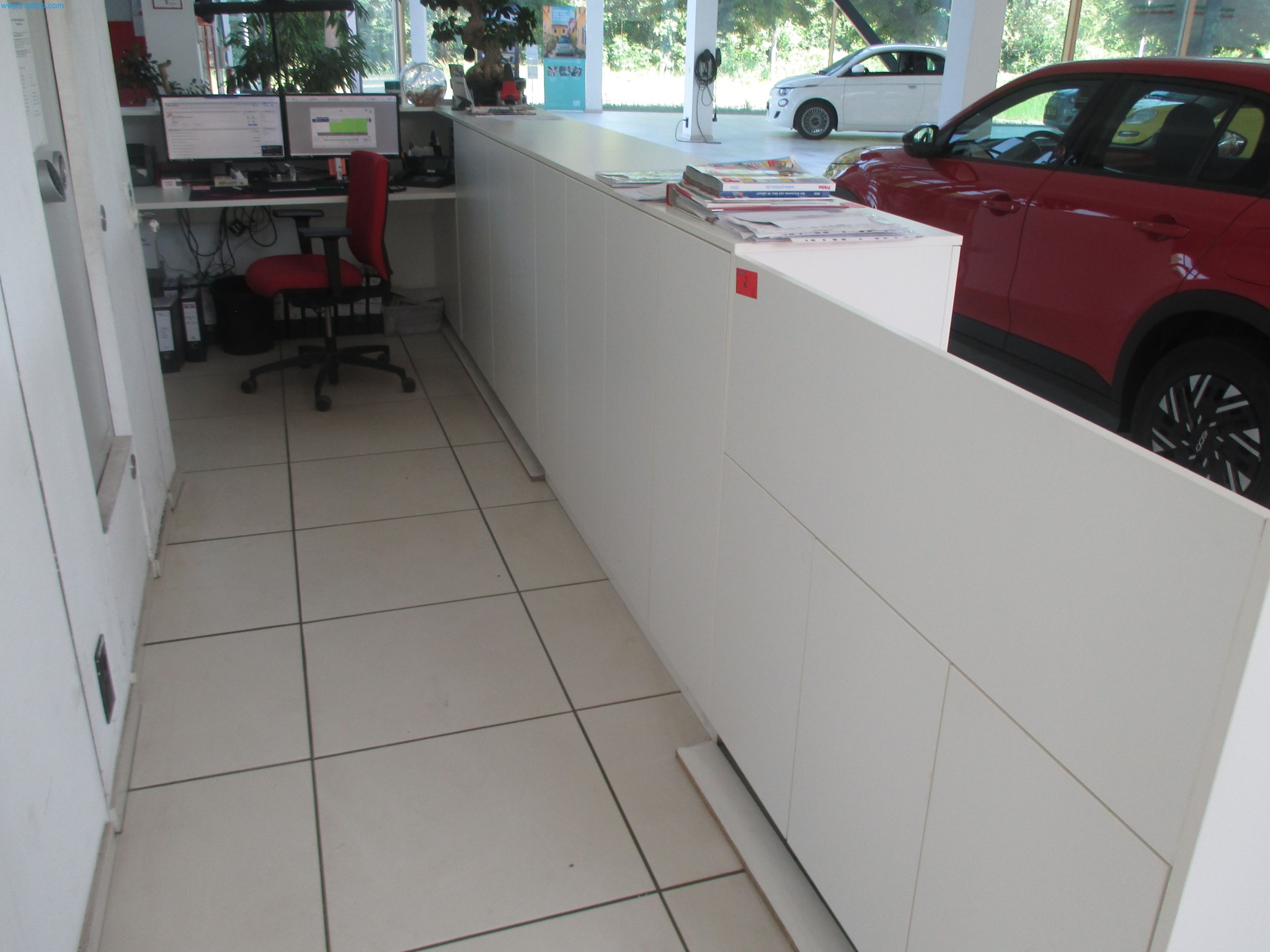 Passenger cars, electric cars, and automotive repair shop equipment at a Fiat dealership-2