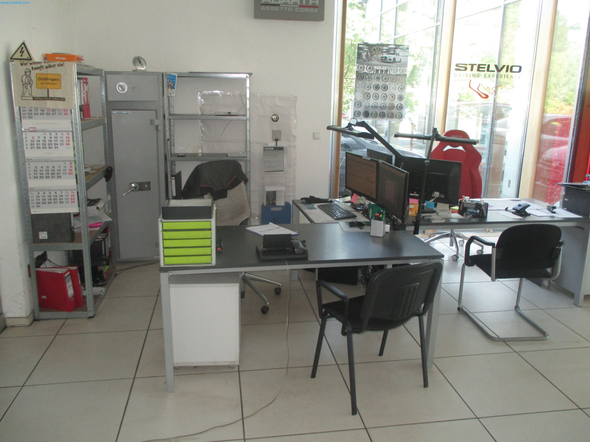 Passenger cars, electric cars, and automotive repair shop equipment at a Fiat dealership-1