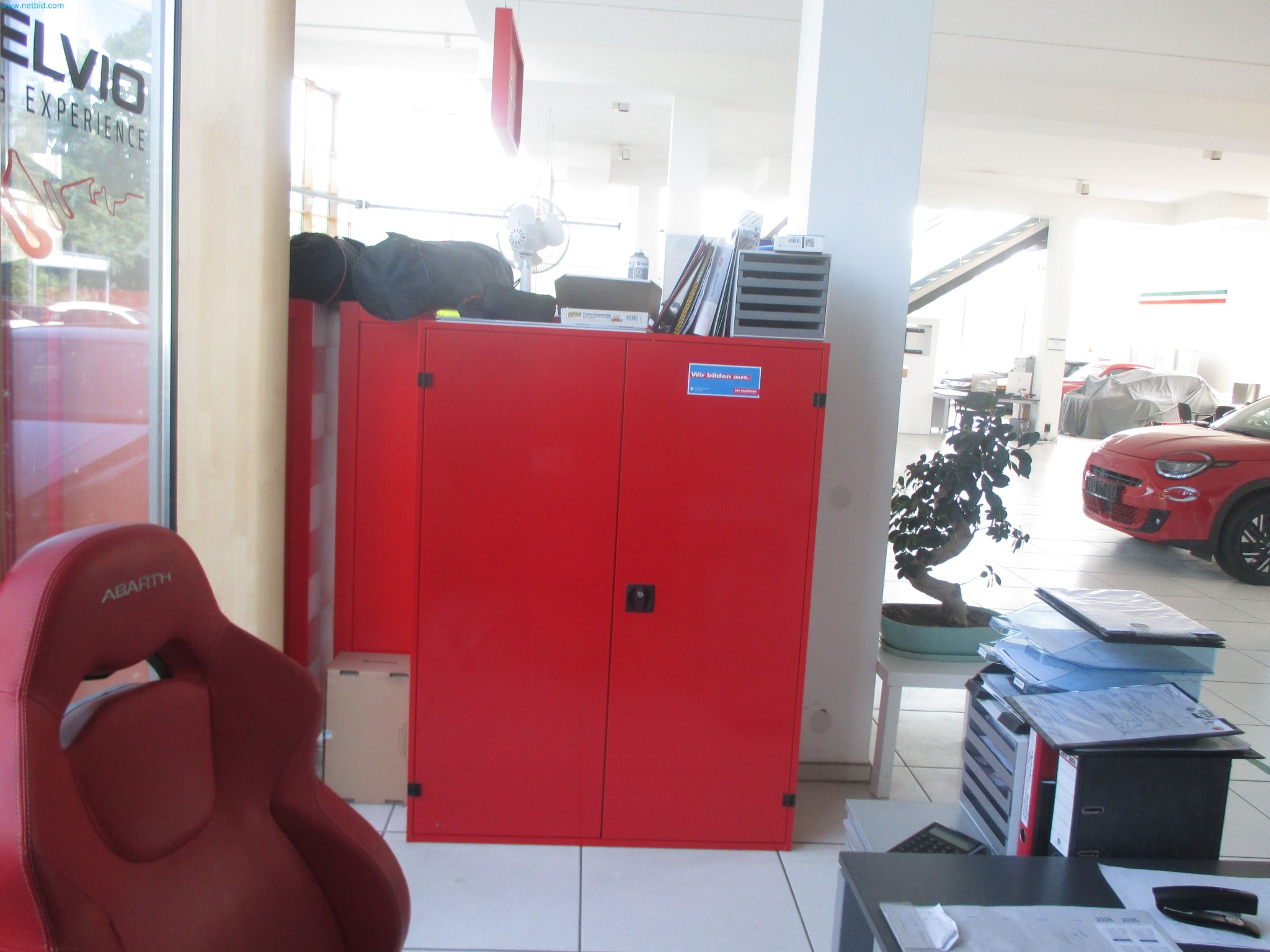 Passenger cars, electric cars, and automotive repair shop equipment at a Fiat dealership-6