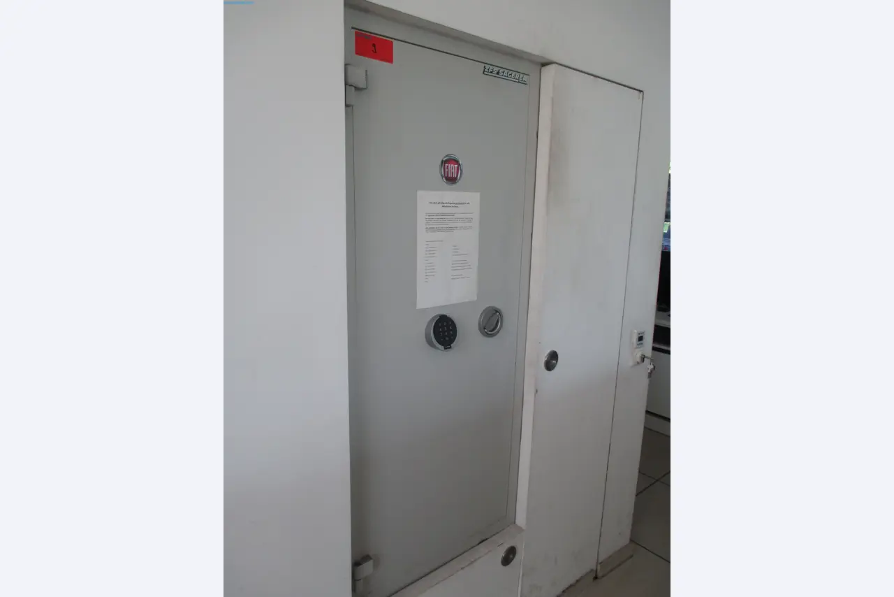Passenger cars, electric cars, and automotive repair shop equipment at a Fiat dealership-1