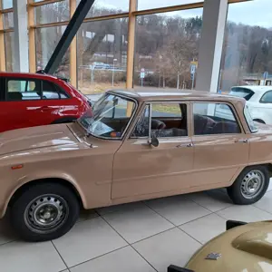 Passenger cars, electric cars, and automotive repair shop equipment at a Fiat dealership