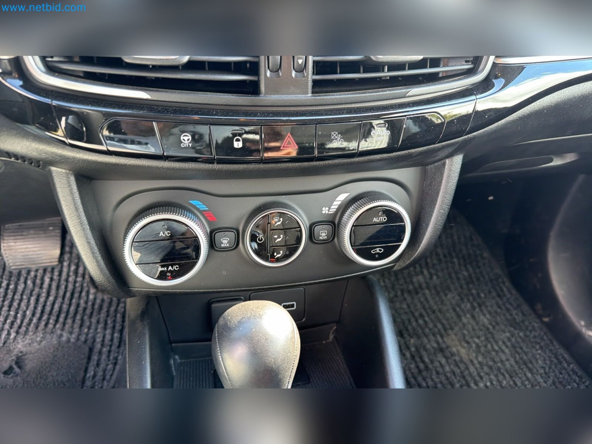 Passenger cars, electric cars, and automotive repair shop equipment at a Fiat dealership-10