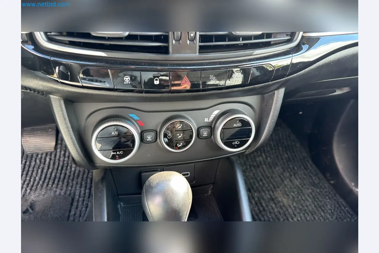 Passenger cars, electric cars, and automotive repair shop equipment at a Fiat dealership-10