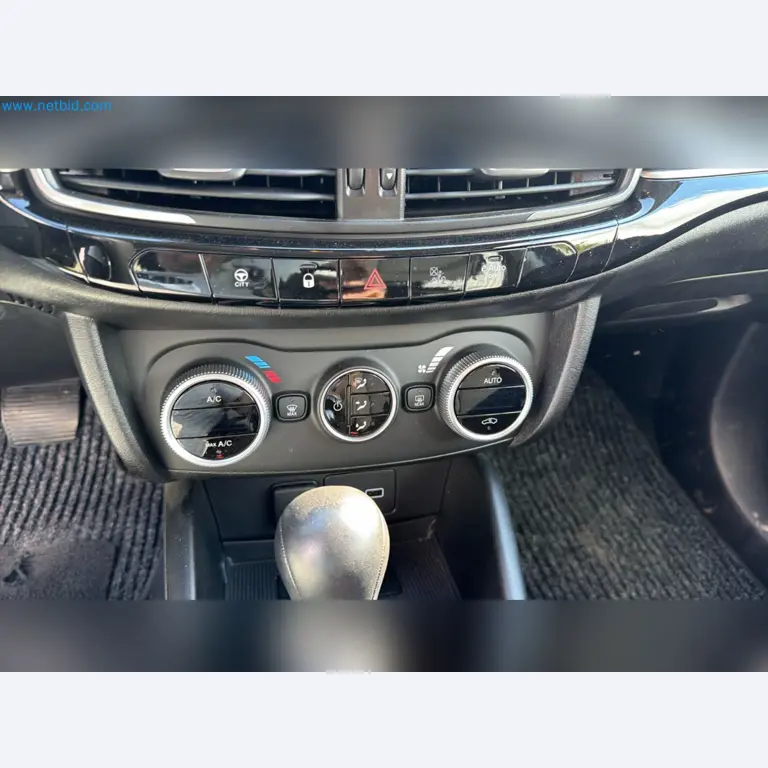 Passenger cars, electric cars, and automotive repair shop equipment at a Fiat dealership-10