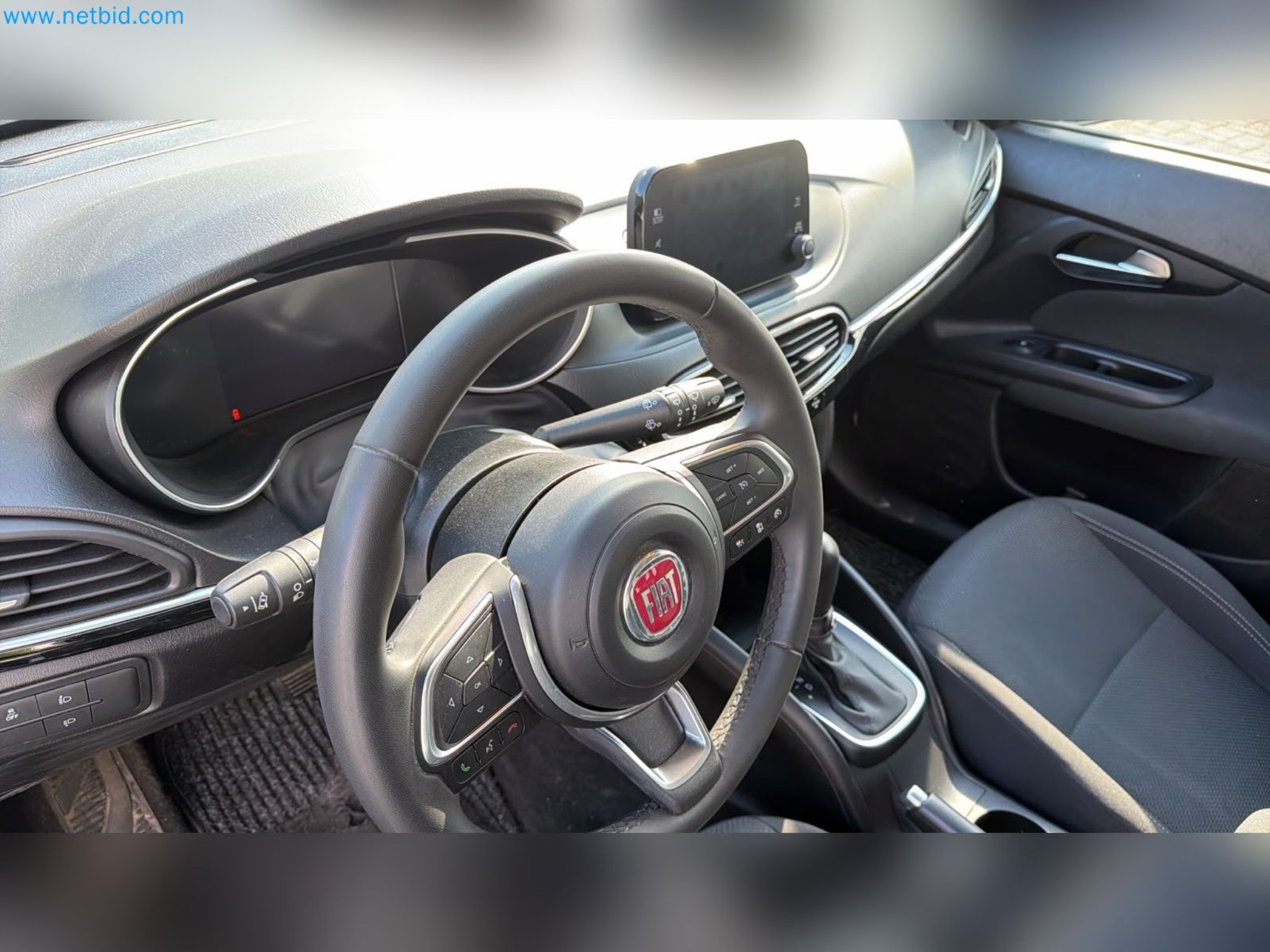 Passenger cars, electric cars, and automotive repair shop equipment at a Fiat dealership-11