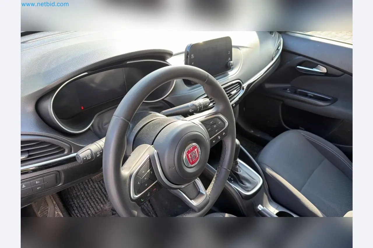 Passenger cars, electric cars, and automotive repair shop equipment at a Fiat dealership-11