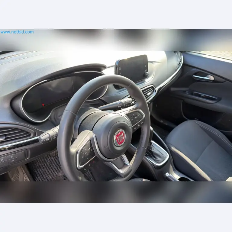 Passenger cars, electric cars, and automotive repair shop equipment at a Fiat dealership-11